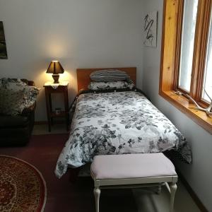 a bedroom with a bed with a comforter and a window at Cricket Hill in Killington