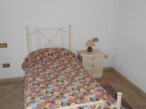 a bed with a quilt on it in a bedroom at Garden in Bastia Umbra