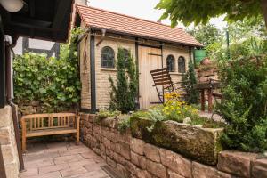 a small shed with a bench in a garden at Fachwerkhaus in Wolfhagen