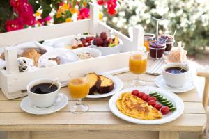 a table with breakfast foods and drinks on it at Portes Houses in Koufonisia