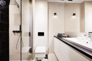 a bathroom with a shower and a sink at Prestige Apartaments 79 in Wrocław
