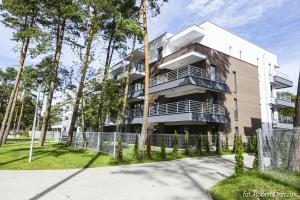 a tall building with trees in front of it at Baltic in Pogorzelica