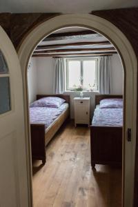 a bedroom with two beds and a window at Fachwerkhaus in Wolfhagen