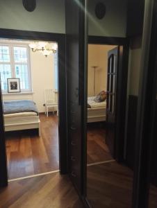 a mirror in a room with a bed and a bedroom at Apartament Ducha 3 in Gdańsk