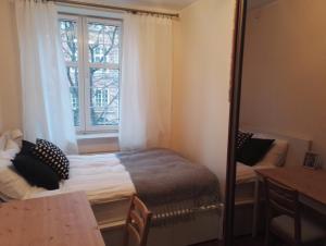 a bedroom with a bed in front of a window at Apartament Ducha 3 in Gdańsk