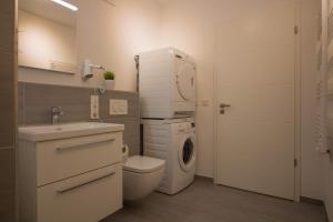 a bathroom with a washing machine and a washer at Wohnen am Yachthafen W45 in Cuxhaven