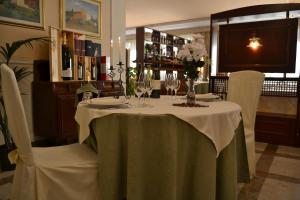 a table with wine glasses and flowers on it at Hotel Forum in Foiano della Chiana