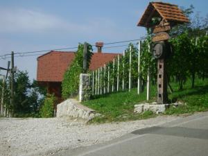 um sinal no lado de uma estrada ao lado de uma cerca em Zidanca med Vinogradi em Otocec