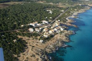 an aerial view of an island in the water at Apartamentos DELFIN in Es Calo
