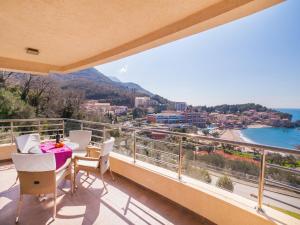 a balcony with a table and chairs and a view at Apartments Raymond in Sveti Stefan
