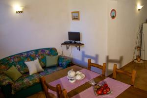 a living room with a couch and a table at Casa Vacanze Il Piccolo Noce in Pietrafitta