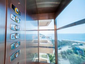 a metal wall with signs on it next to a window at Apartments Raymond in Sveti Stefan