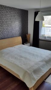 1 cama grande en un dormitorio con pared en Ferienhaus Lemafri Duhnen, en Cuxhaven