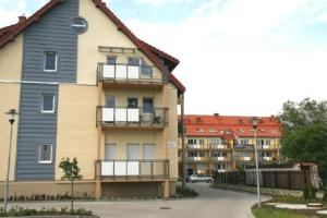 a large building with balconies and a parking lot at Apartamenty w Stegnie in Stegna