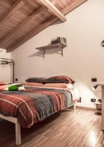 a bedroom with a bed and a shelf on the wall at Casa Rosa in Luisago