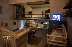 a living room with a couch and a television at Vila Alba in Fortim