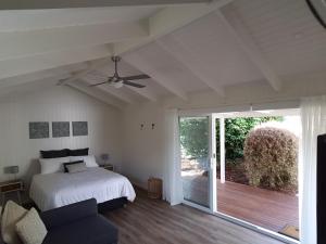 a bedroom with a bed and a sliding glass door at Alkira in Leongatha