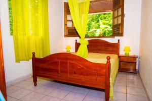 Postel nebo postele na pokoji v ubytování Les Fleuris 972