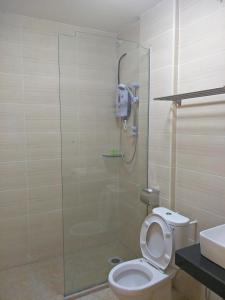 a bathroom with a shower with a toilet and a sink at Anderson Hotel in Ipoh