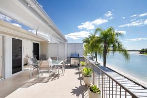 a balcony with a view of the water at Noosa Haven Apt 12 Riverfront Elegance in Noosaville