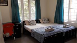 Postel nebo postele na pokoji v ubytování The Pod Cochin Homestay