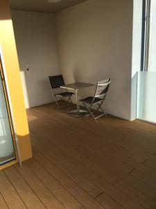 een eetkamer met een tafel en 2 stoelen bij Close to Zürich centre and Airport in Kloten