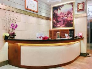 a reception counter at a restaurant with a painting on the wall at Hi-Star View Hotel in Xizhi