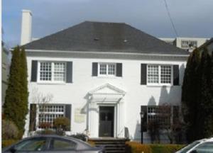 a white house with a black roof at Doyle Lovejoy in Portland
