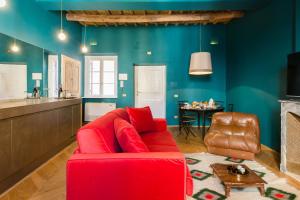 een woonkamer met een rode bank en een tafel bij Glamour Leonina - Monti in Rome