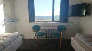 a room with a table and two chairs and a bed at Danhostel Nykøbing Mors in Nykøbing Mors