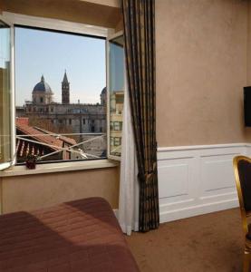 a room with a window with a view of a city at Relais La Maison De Luxe in Rome
