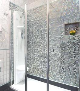 a shower with a glass door in a bathroom at Relais La Maison De Luxe in Rome +15 photos