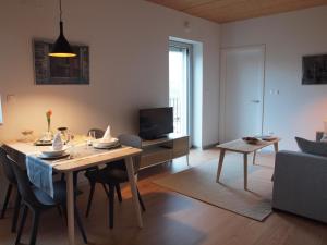 a dining room and living room with a table and a television at Mendialdea Amaiur Baztán in Maya del Baztán