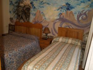 Posteľ alebo postele v izbe v ubytovaní Hostal Tribal
