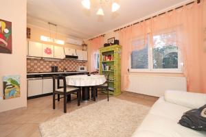 a kitchen and living room with a table in a room at Apartments Sanja in Vodice