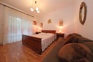 a bedroom with a bed and a couch at Apartments Sanja in Vodice