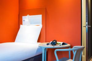 a room with a bed and a table and a chair at ibis budget Rotterdam The Hague Airport in Rotterdam