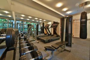a gym with a row of treadmills and machines at Mama's Design & Boutique Hotel in Bratislava