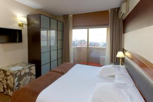 Łóżko lub łóżka w pokoju w obiekcie Oca Ipanema Hotel