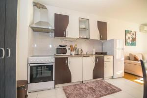 a kitchen with a stove and a microwave at Apartment Matmar in Split