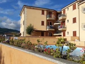 - une vue sur un bâtiment avec piscine dans l'établissement Residenza I Gabbiani Valledoria, à Valledoria