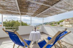 a patio with chairs and a table on a balcony at Apartments Amulic in Duće