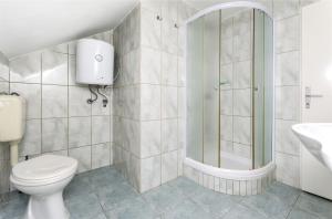 a bathroom with a shower and a toilet and a sink at Apartments Toni in Vodice +27 photos