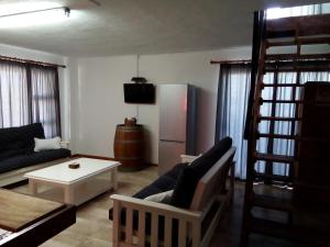a living room with a couch and a refrigerator at Little Sister's in Colchester