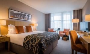 a hotel room with a bed and a desk at Clayton Hotel Belfast in Belfast