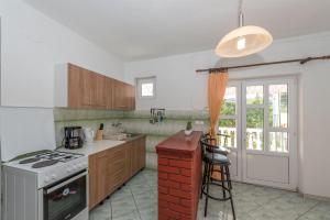 a kitchen with a stove top oven next to a counter at House Zdenka in Tribunj