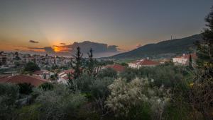 a view of a city with the sunset in the background at Magic Touch in Shelomi