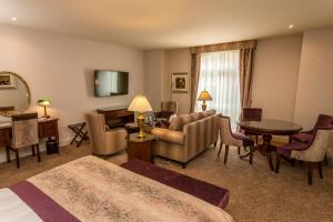 a hotel room with a bed and a living room at Swan's Nest Hotel in Stratford-upon-Avon