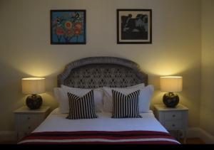 a bedroom with a large bed with two lamps at Haldon Priors in Torquay