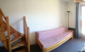ブール・サン・モーリスにあるLes Olympiadesの階段とソファ付きのベッドが備わる客室です。